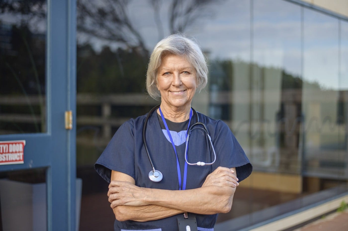 female-clinician-confident-pose-with-stethoscope Female clinician posing confidently with stethoscope, symbolising healthcare leadership and trust in user-centered design.